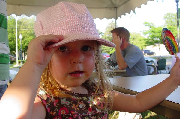 Chloe with her choochoo train hat and lollipop