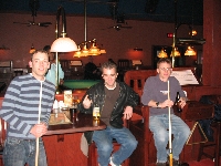 Dudes chilling with their pool sticks